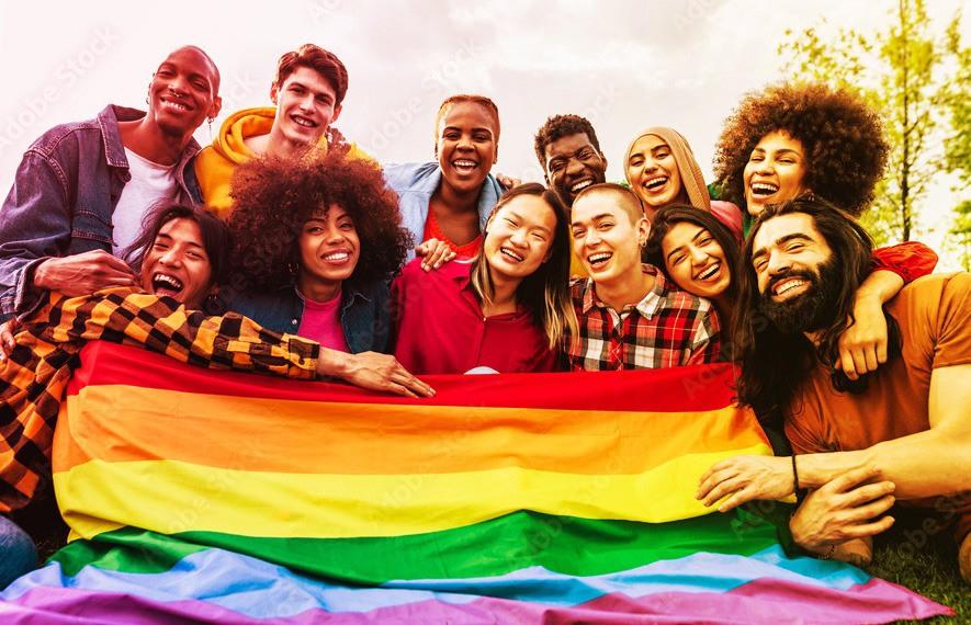 A group of people holding a pride flag